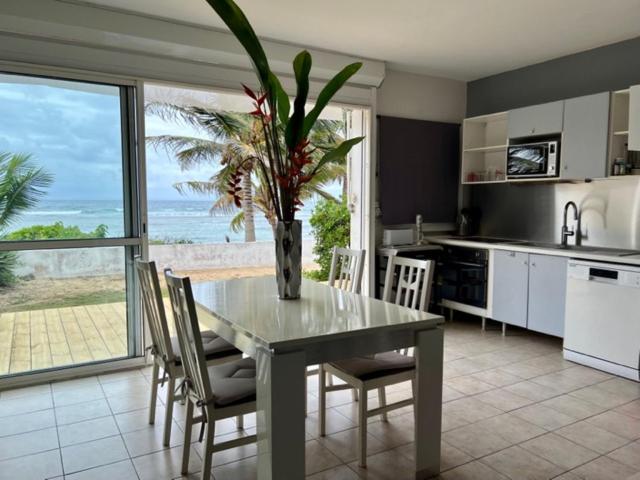 a kitchen with a table with a vase on it at LE REV&#39;ANOU in Sèze