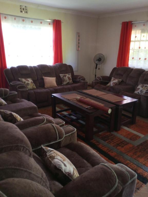 a living room with couches and a coffee table at Annex in Kakamega