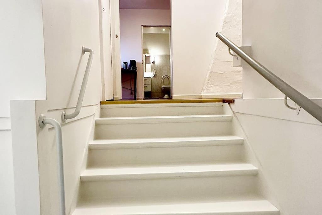 a stairway with white steps and a hallway at Penthouse nära Liseberg - Mässan - Avenyn in Gothenburg