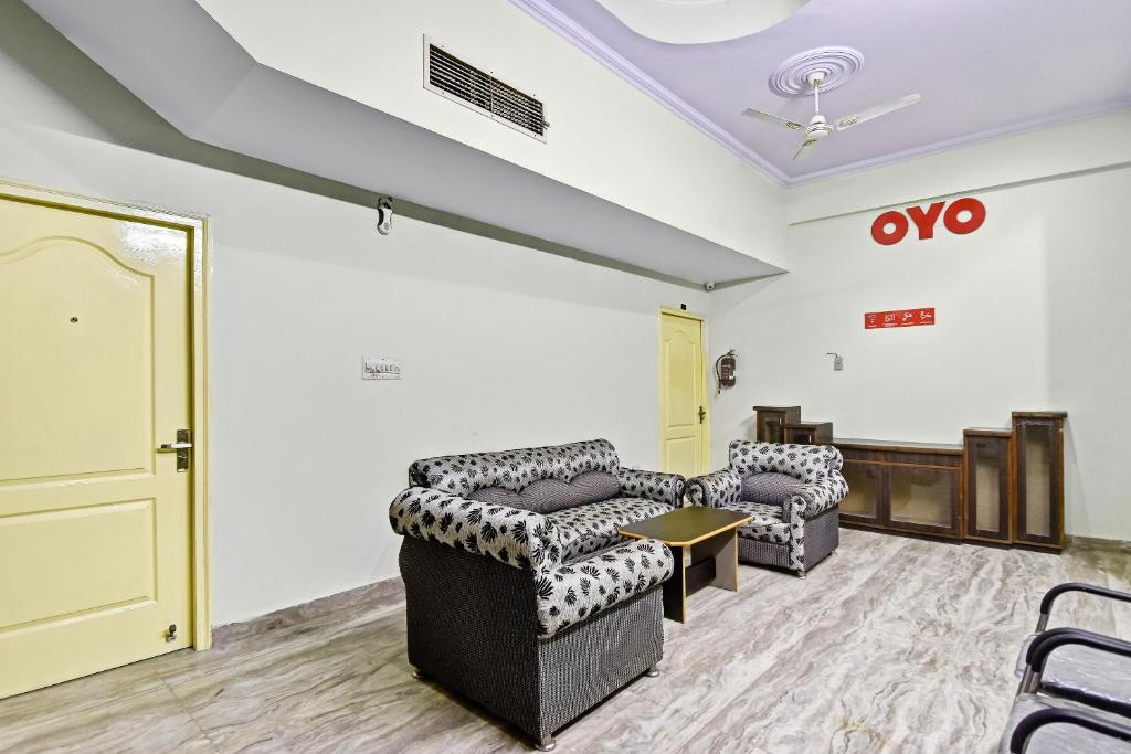 een wachtkamer met twee banken en een deur bij OYO Flagship 47164 Madhav Palace in Jaipur