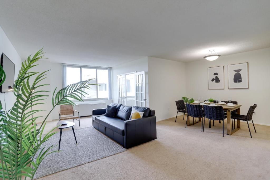 a living room with a couch and a table at Incredible 1 BR Apt + Den @Crystal City With Gym in Arlington