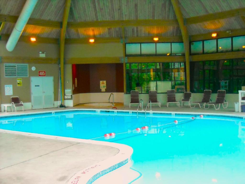 a large swimming pool in a large building at Stylish Townhouse Steps to Ski Mtn & Waterpark in Tannersville