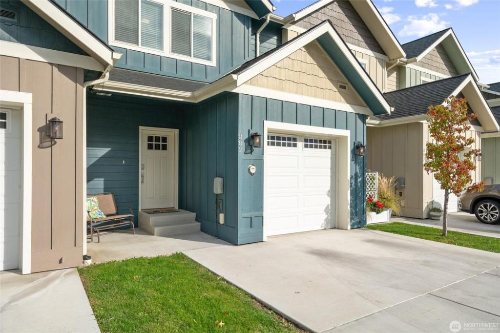 a blue house with a white garage at New Town House - Heart of Wenatchee in Wenatchee