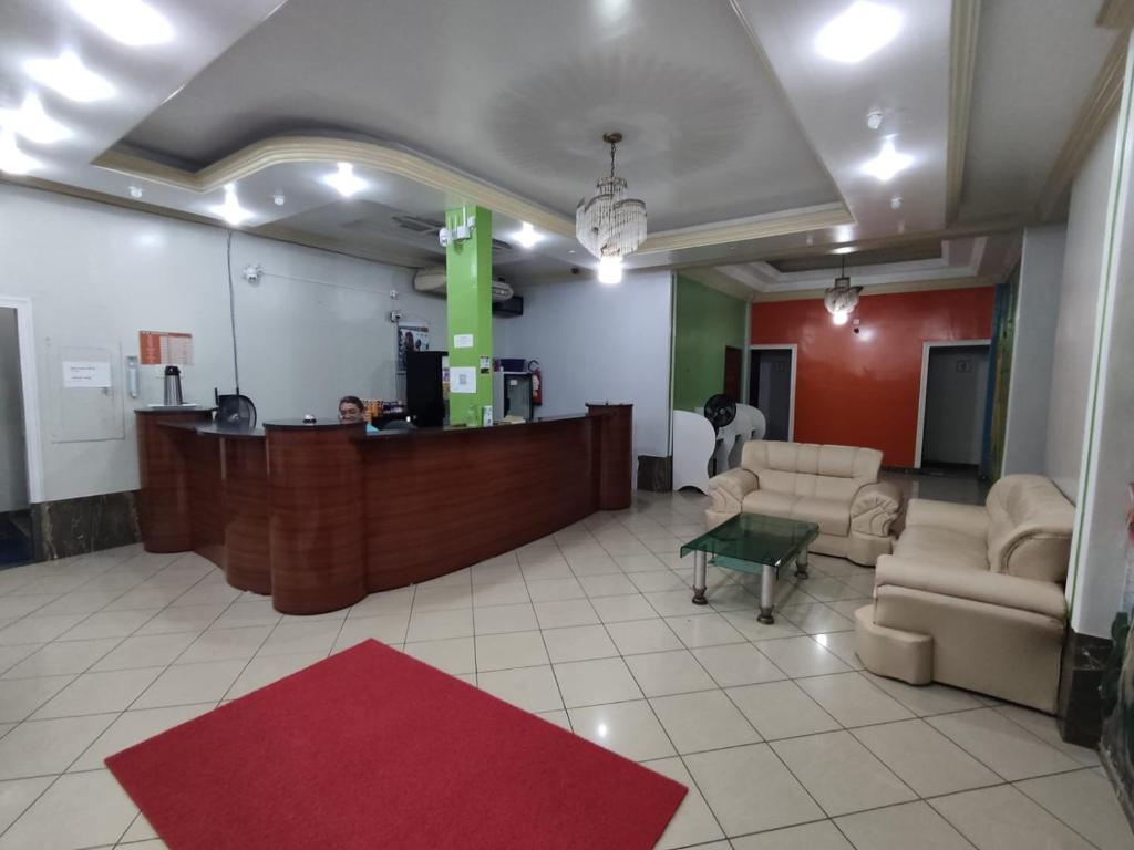 a lobby with a reception desk and a red rug at HOTEL NEW´S BUSINESS in Macapá