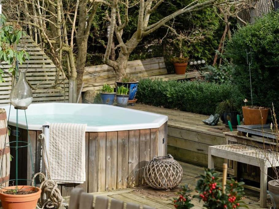 a bath tub in a garden with potted plants at The Royal home - Liseberg / Svenska Mässan in Gothenburg