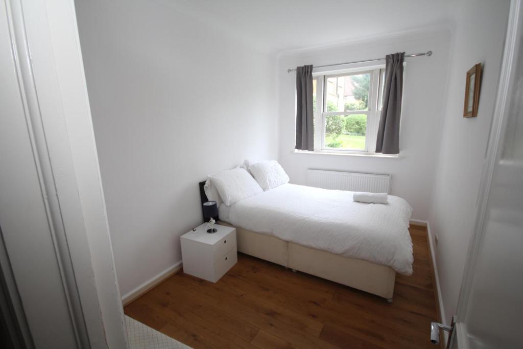 a small bedroom with a bed and a window at Harrow On The Hill Place in London