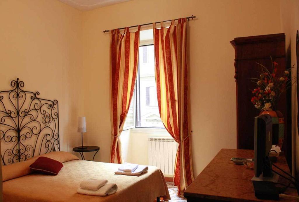 Postel nebo postele na pokoji v ubytování Hotel Campidoglio