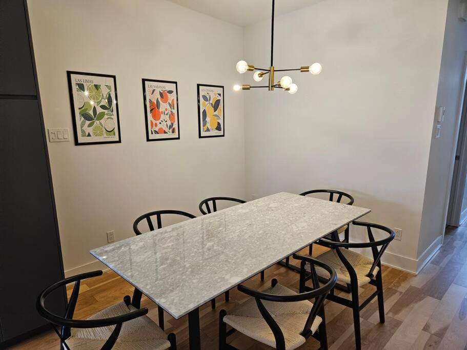 a dining room with a table and some chairs at Chic Modern Apt in The Plateau in Montreal