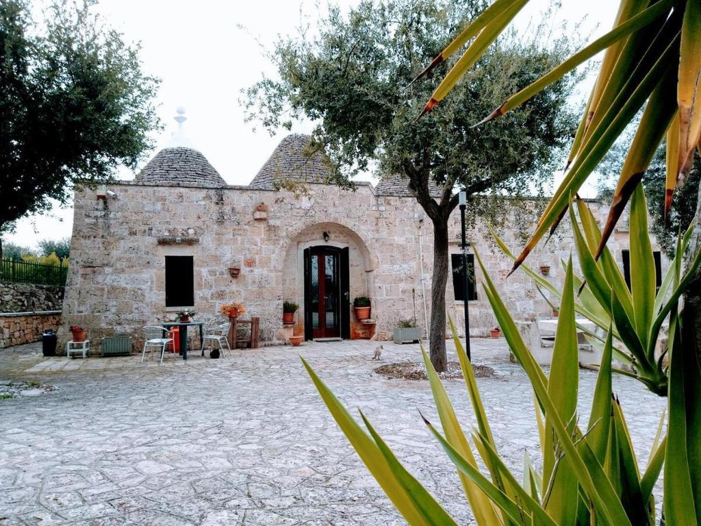 an external view of a building with a courtyard at La magia del trullo in Martina Franca