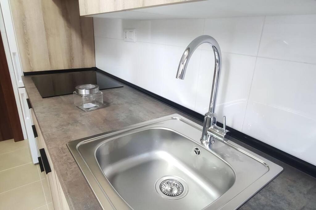 a kitchen sink with a faucet on a counter at Apartamento Hogar del Nómada in Gibaja