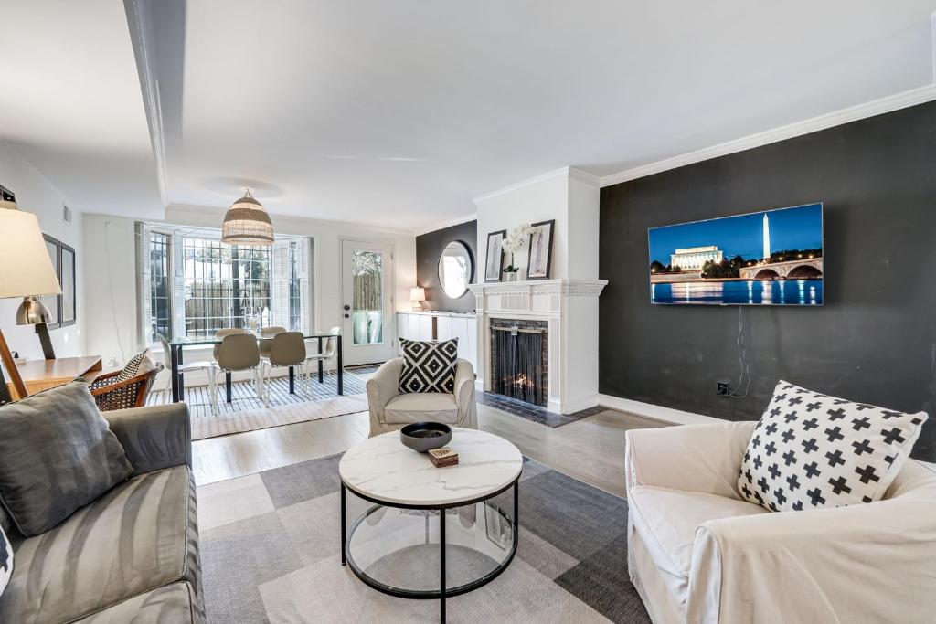 a living room with two couches and a fireplace at Chic & Central Foggy Bottom DC Stay in Washington