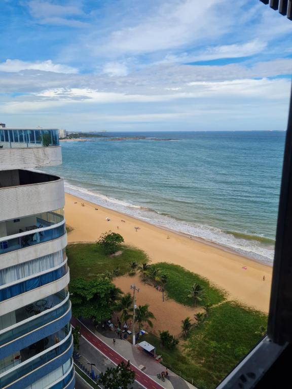 a view of the beach from a building at Flat Praia da Costa in Vila Velha