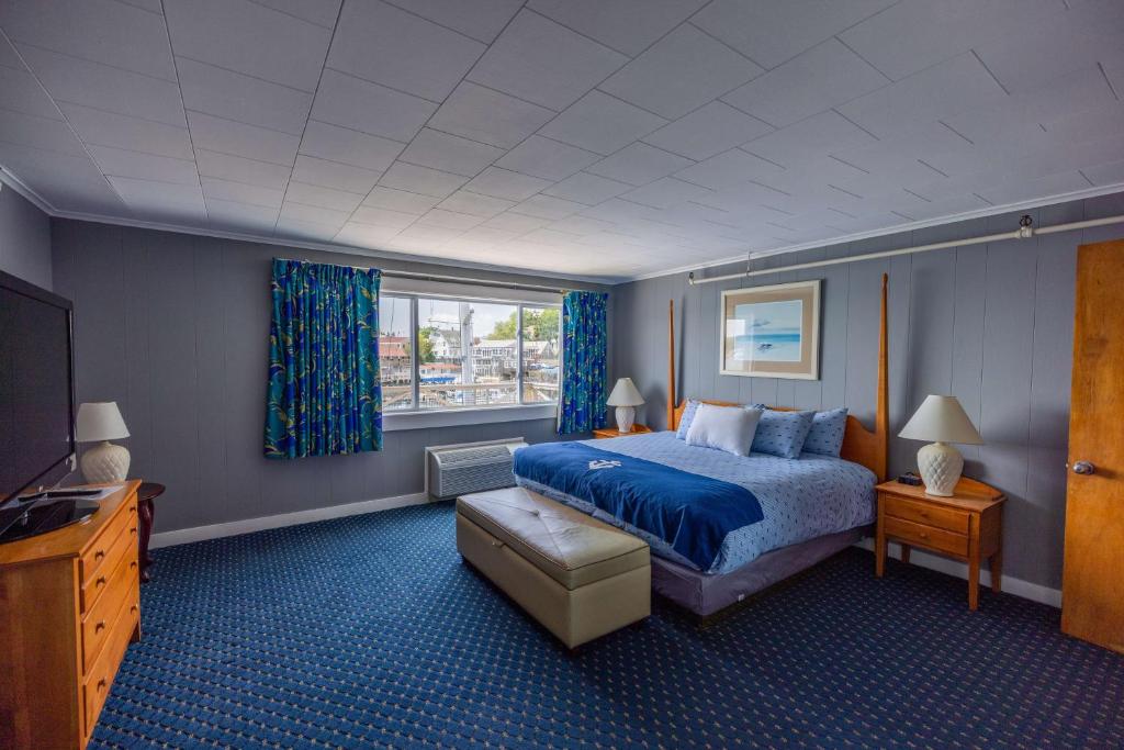 a hotel room with a bed and a television at Fisherman's Wharf Inn in Boothbay Harbor