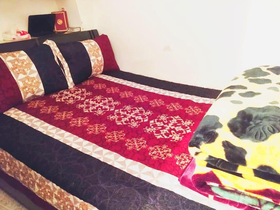 a bed with a colorful blanket on top of it at House in Rabat medina best vibe in Rabat