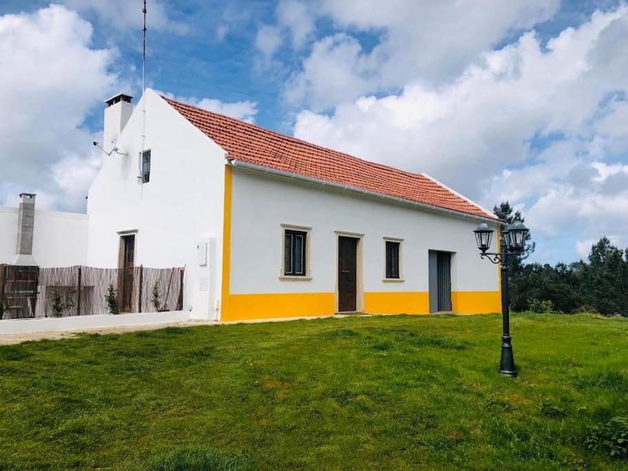 a white church with a red roof at Quinta da Casa Azul in Óbidos
