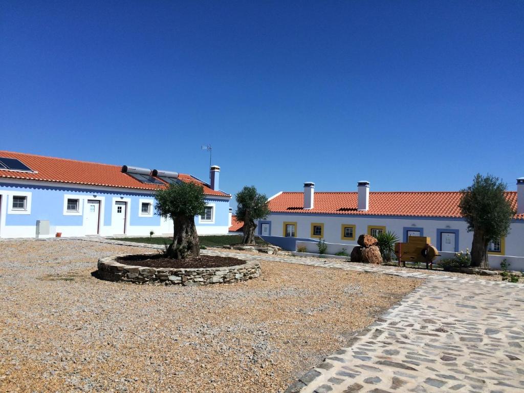 a woman sitting in front of a building at Casas de Miróbriga in Santiago do Cacém