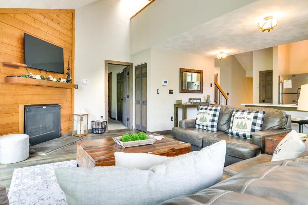 a living room with a couch and a fireplace at Somerset Townhome with Deck Less Than 2 Mi to Ski Lift! in Champion