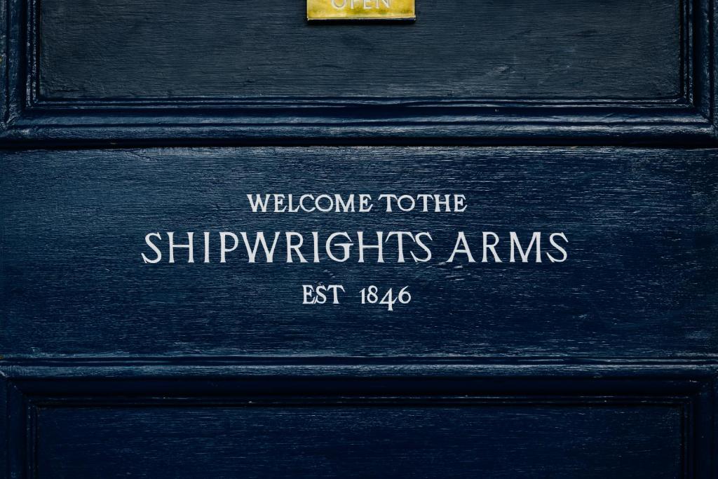 a wooden door with a welcome to the shippetharmsarms est at Shipwrights Arms Hotel in Hobart
