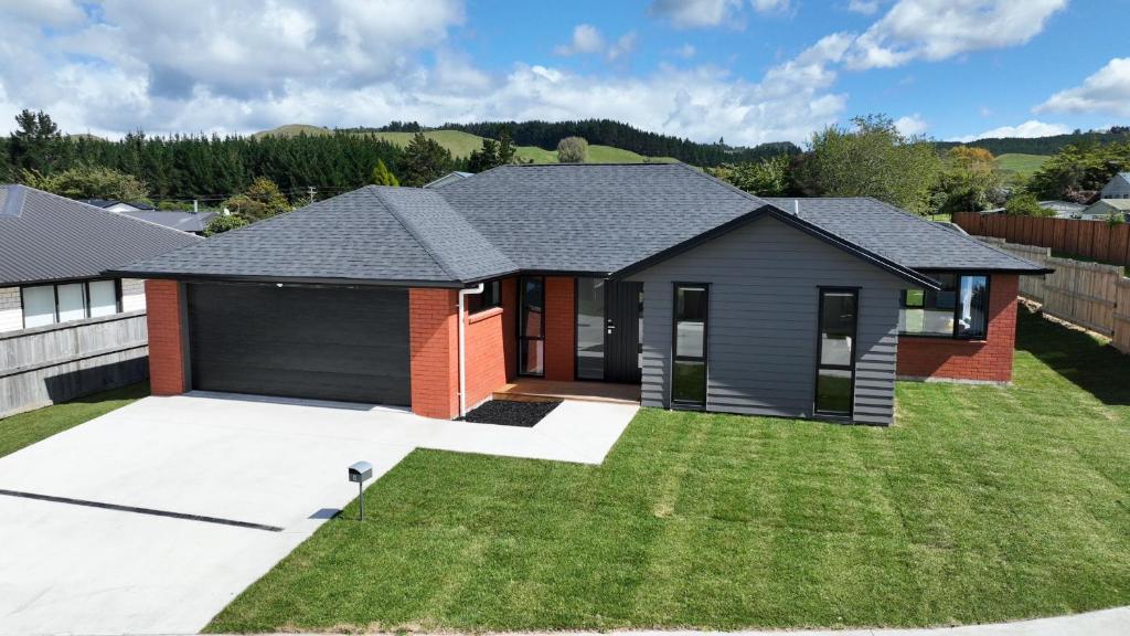 a house with a garage at Brand New House with 5 bedroom and 3 full bathroom in Rotorua