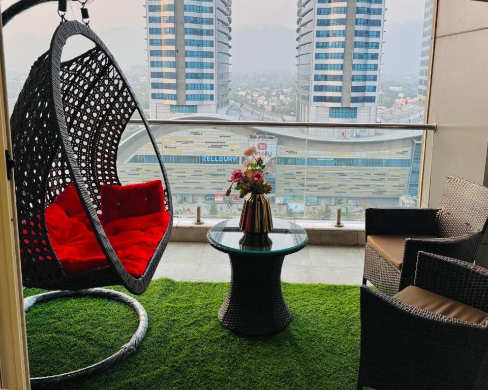 a room with a hammock and a table and a window at Elysium Tower Retreat Luxury Living Opposite Centaurus Mall - Islamabad in Islamabad
