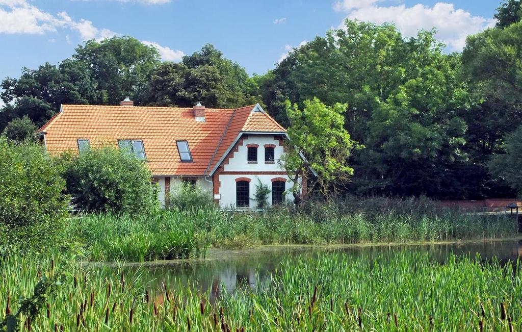 an old house on the side of a lake at 2 Bedroom Beautiful Home In Hohen Demzin in Hohen Demzin