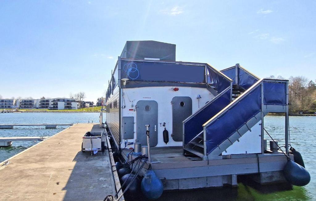 a boat is docked at a dock on the water at 3 Bedroom Lovely Ship In Waren mritz in Waren