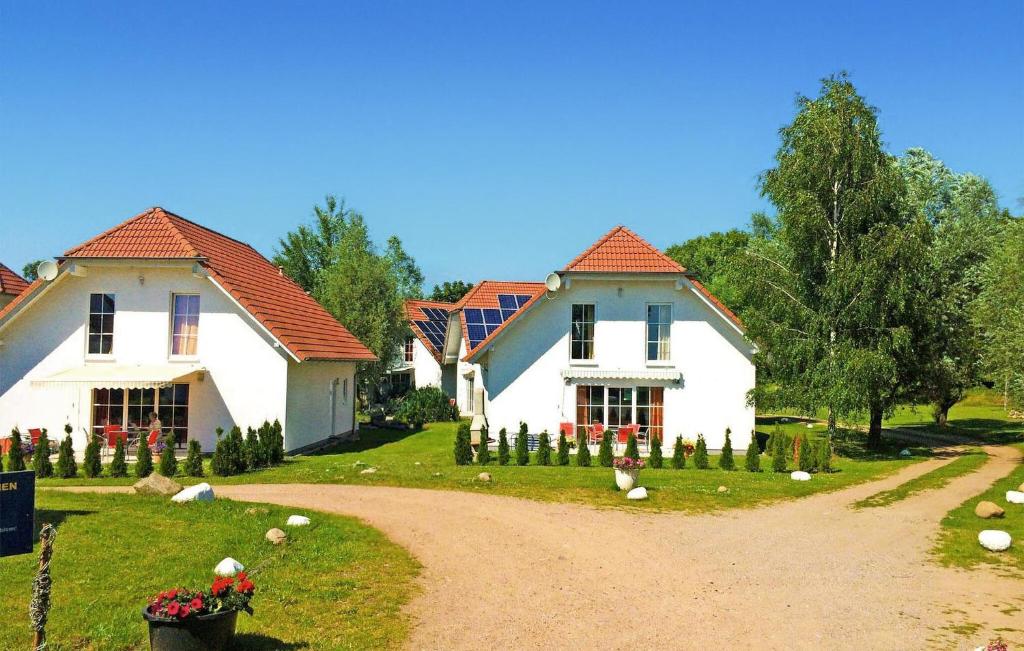 two white houses with red roofs on a dirt road at 3 Bedroom Stunning Home In Verchen in Verchen