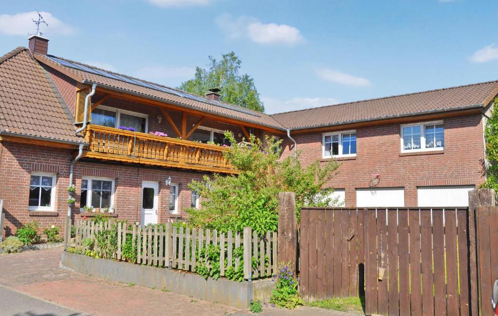 een stenen huis met een houten hek ervoor bij Gorgeous Apartment In Ankershagen With Kitchen in Ankershagen