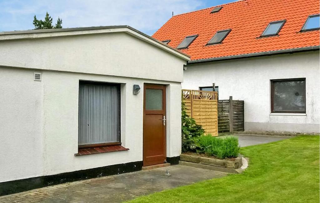 a white house with an orange roof at 1 Bedroom Cozy Apartment In Jennewitz in Jennewitz