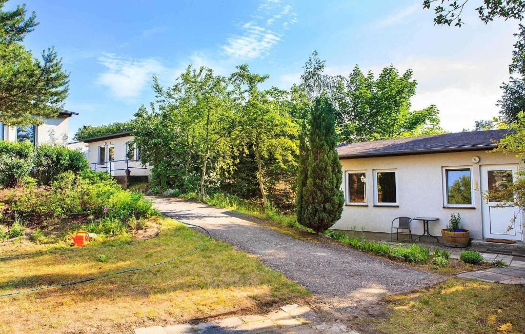 a house with a garden and a driveway at Lovely Apartment In Rheinsberg Ot Kagar With Kitchen in Kagar