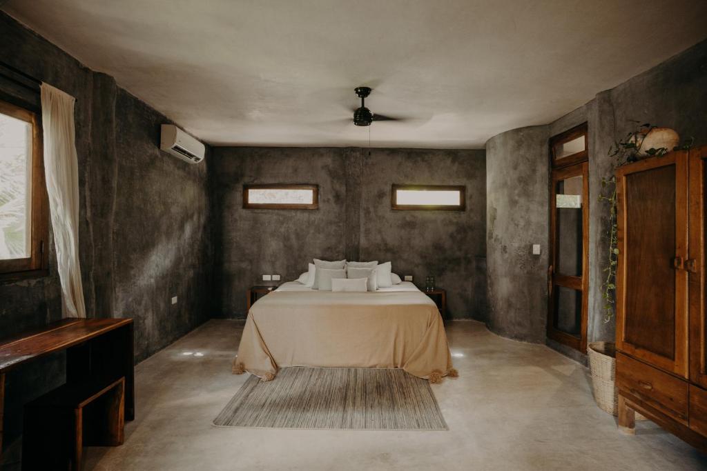 a bedroom with a bed in a room at Sacred Hideaways in Tulum