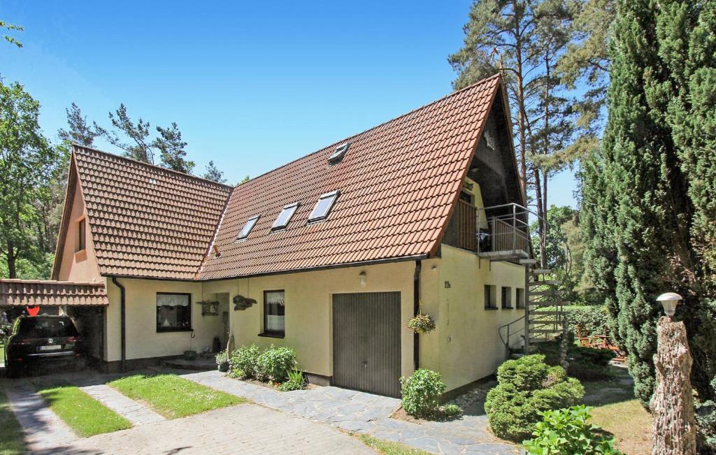 a large yellow house with a brown roof at Nice Apartment In Dierhagen ostseebad With Wifi in Neuhaus