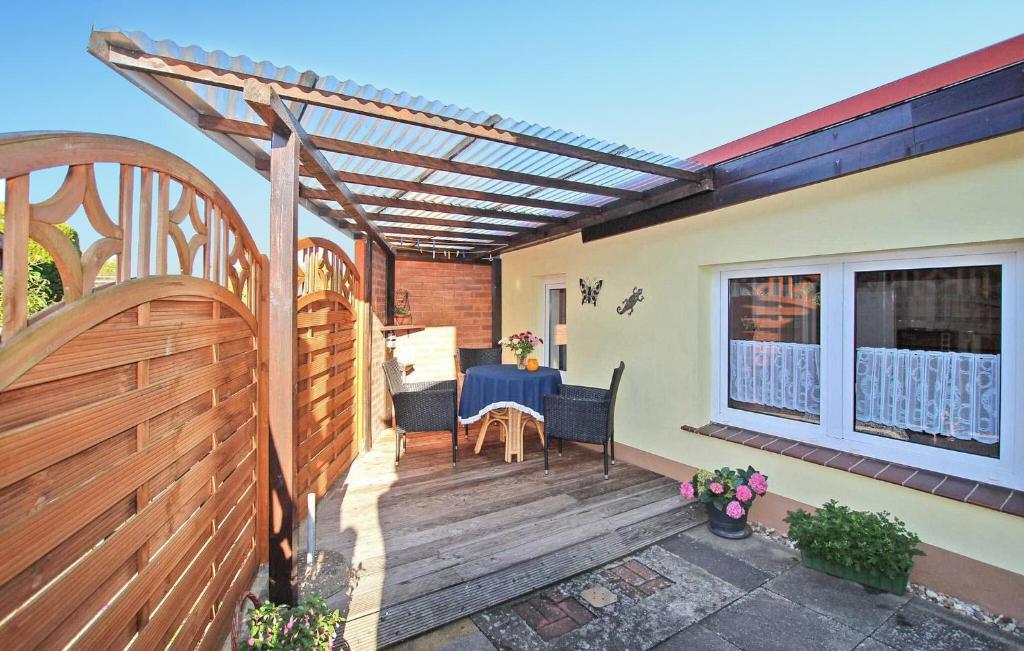 a wooden deck with a table and a pergola at Nice Home In Waren mritz With Kitchen in Warenshof