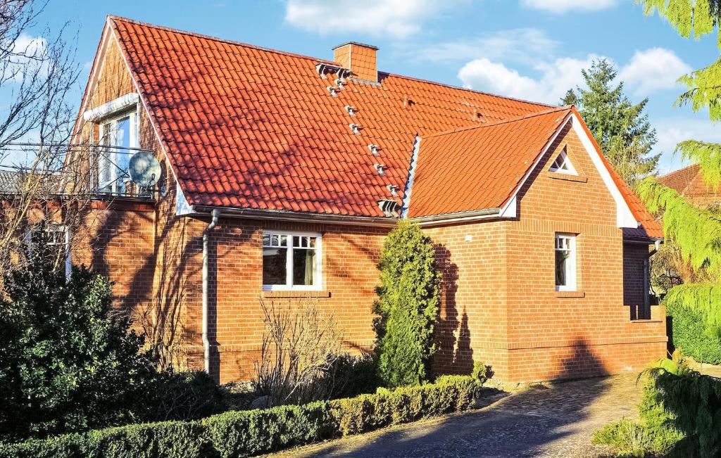 a brick house with an orange roof at 2 Bedroom Beautiful Home In Wokuhl-dabelow in Wokuhl
