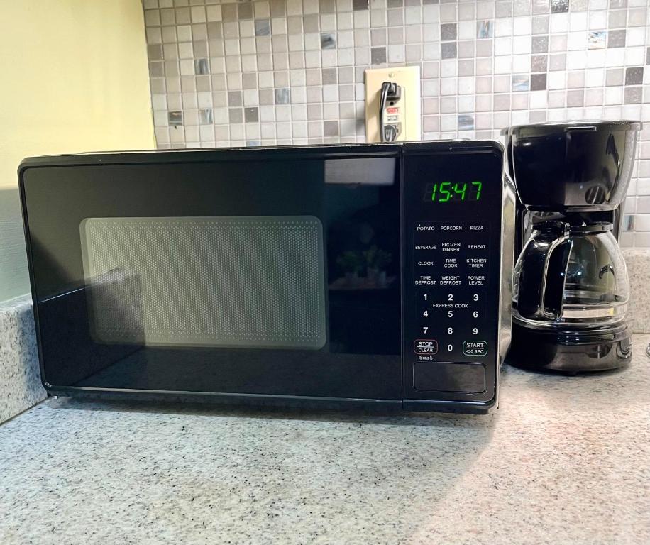 a microwave sitting on a counter with a coffee maker at cozy corner in Philadelphia