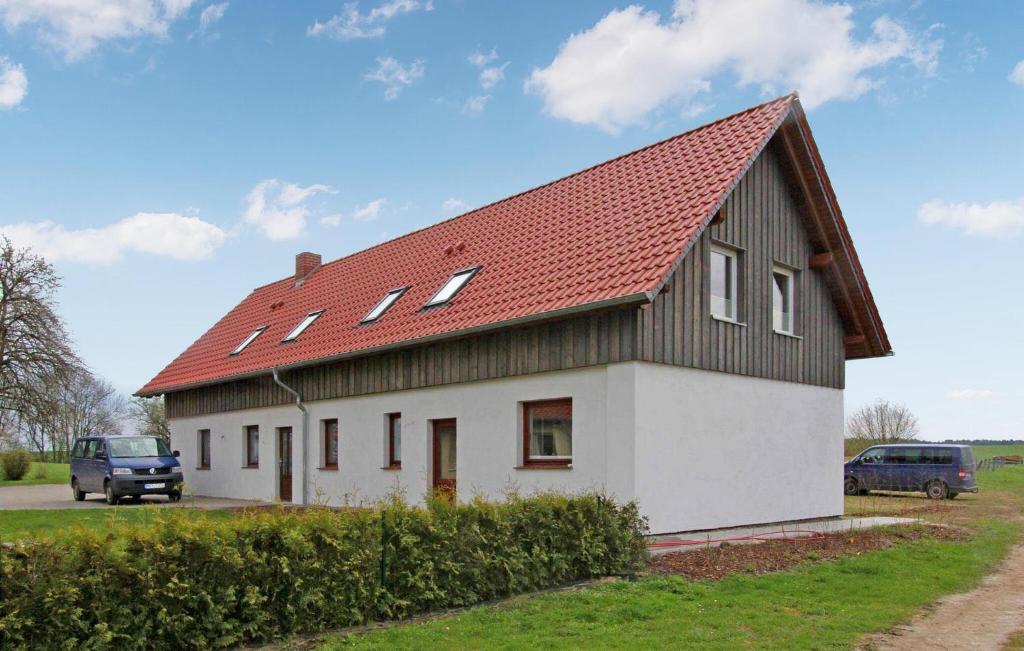 a white and black house with a red roof at Amazing Apartment In Mirow With Kitchen in Mirow