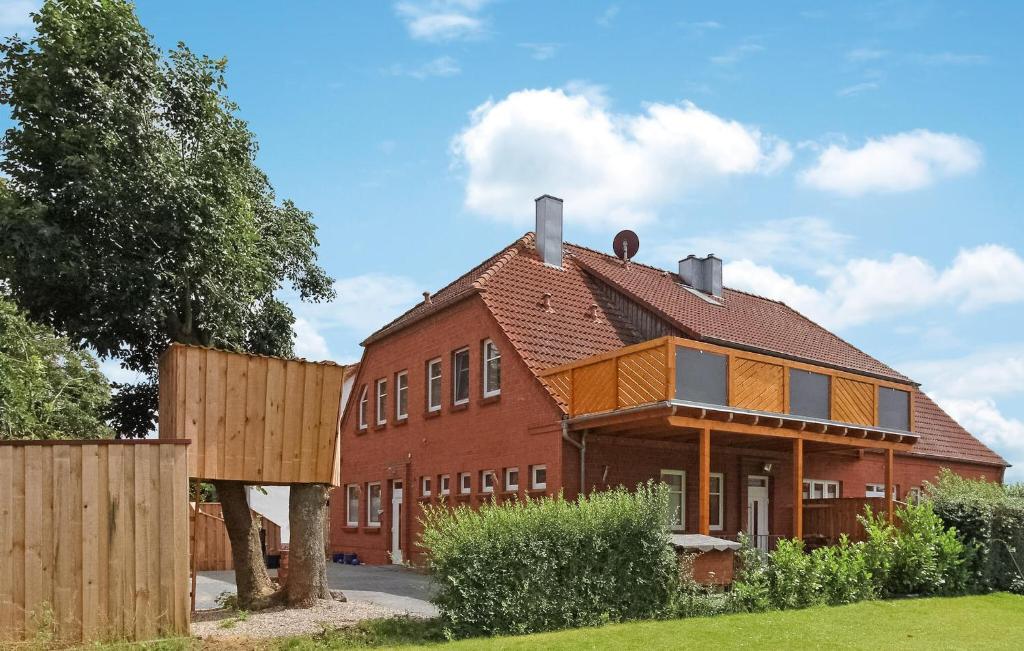 a large red brick house with a wooden fence at Awesome Apartment In Klink With Wifi in Klink