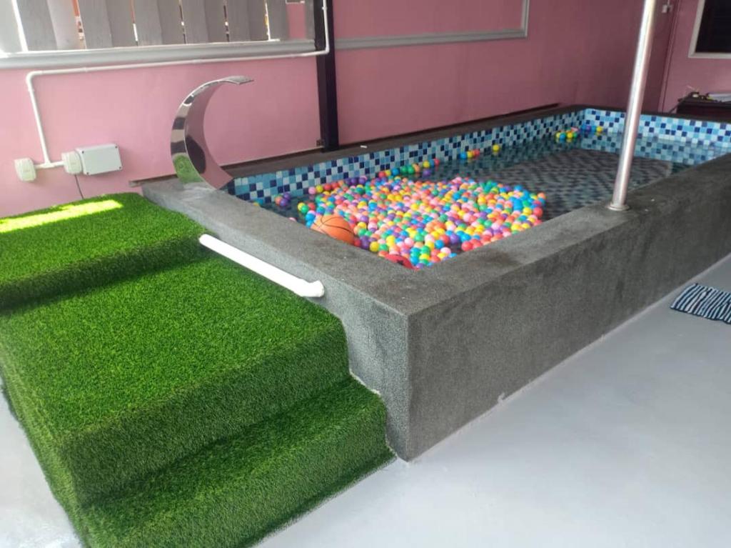 a bathroom with a pool with balls in it at Ria Homestay & kolam in Alor Setar