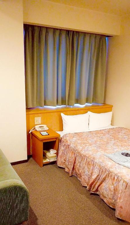 Postel nebo postele na pokoji v ubytování Yonago Universal Hotel