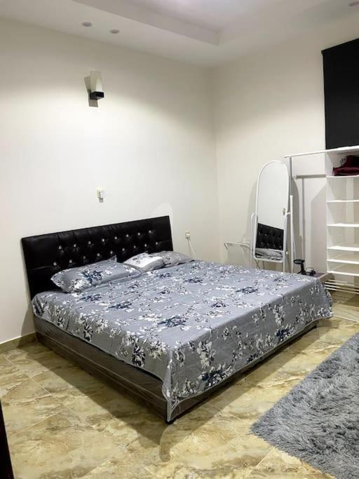 a bedroom with a bed in a white room at استديو في حي النهضة - دخول ذكي ٤أ in Buraydah