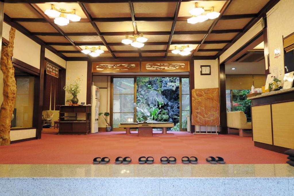 a lobby with a table in the middle of a room at Yokikan in Ito