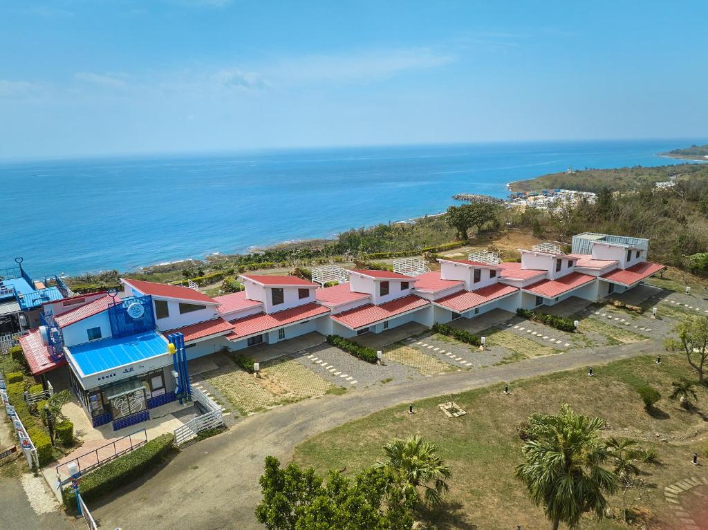 an aerial view of a house with the ocean in the background at Cliff Villa in Hengchun