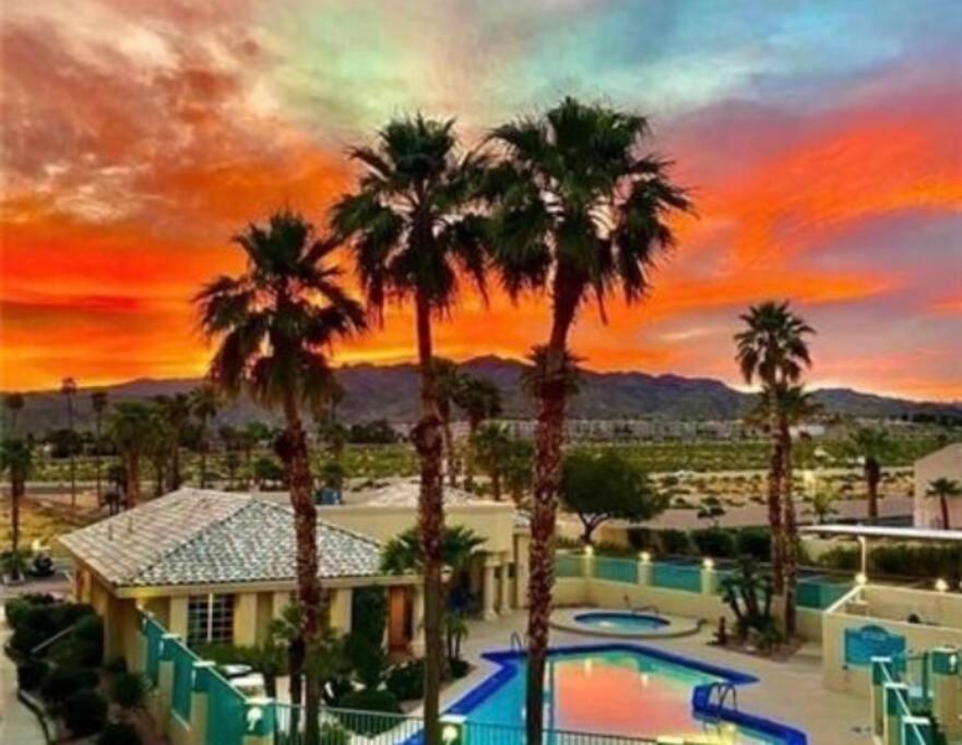 a view of a resort with palm trees and a pool at The Healing Place in Laughlin