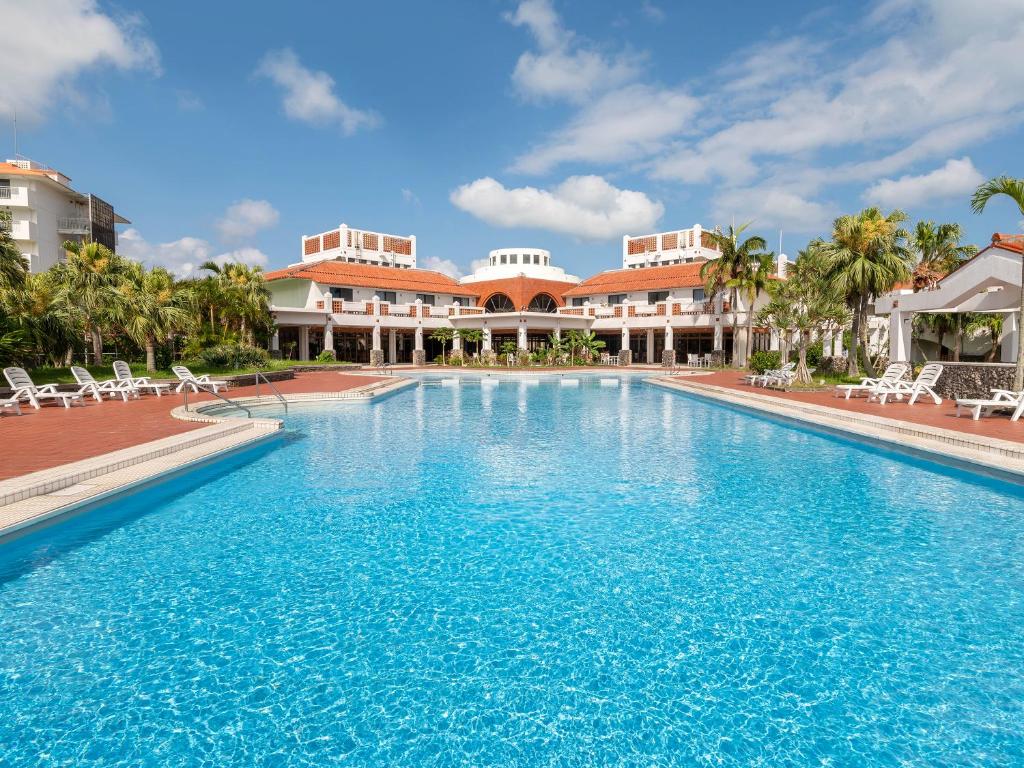 a large swimming pool in front of a resort at Resort Hotel Kume Island in Kumejima
