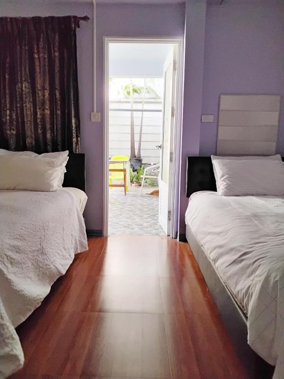 Postel nebo postele na pokoji v ubytování Mango Tree Guestroom