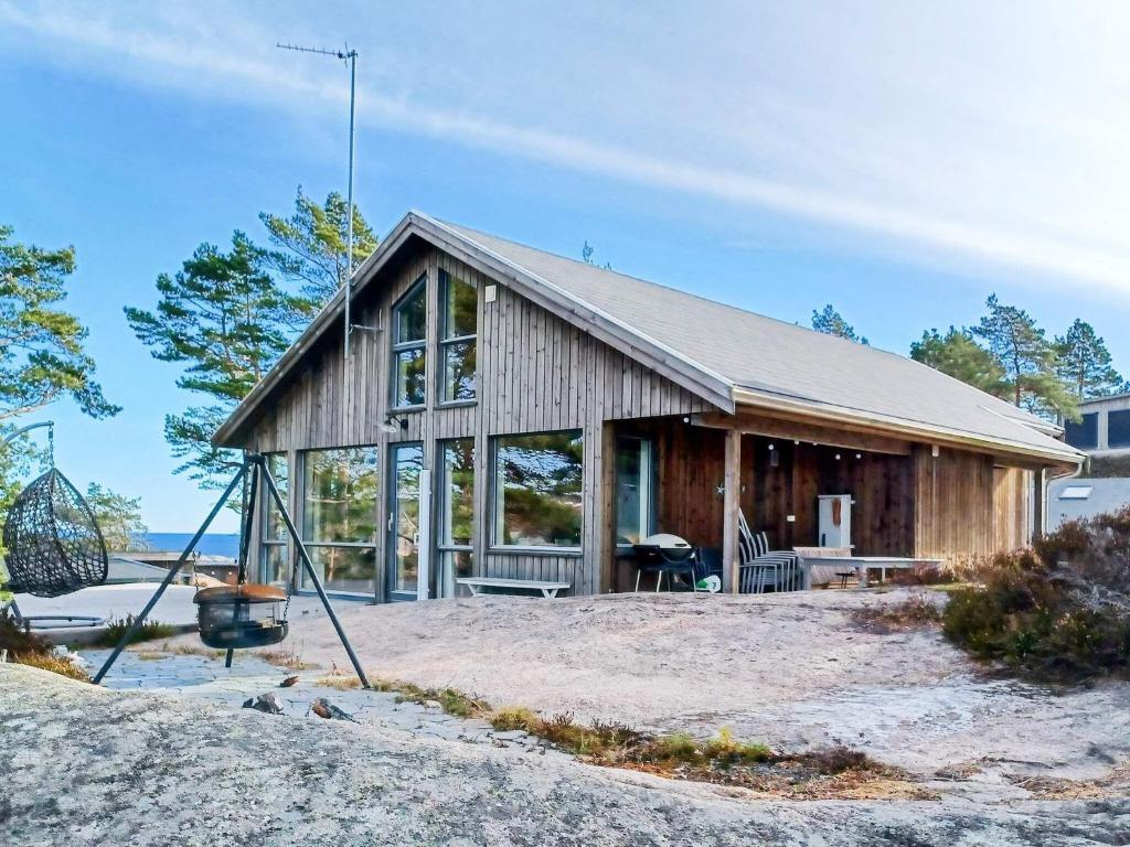 a house on the shore of a lake at 8 person holiday home in Risør-By Traum in Risør