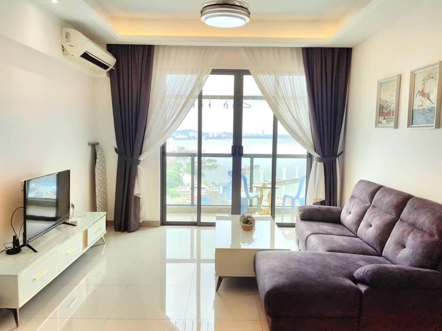 a living room with a couch and a tv at Sofia Superior Suite 2R2B-61258 at R&F Princess Cove in Johor Bahru