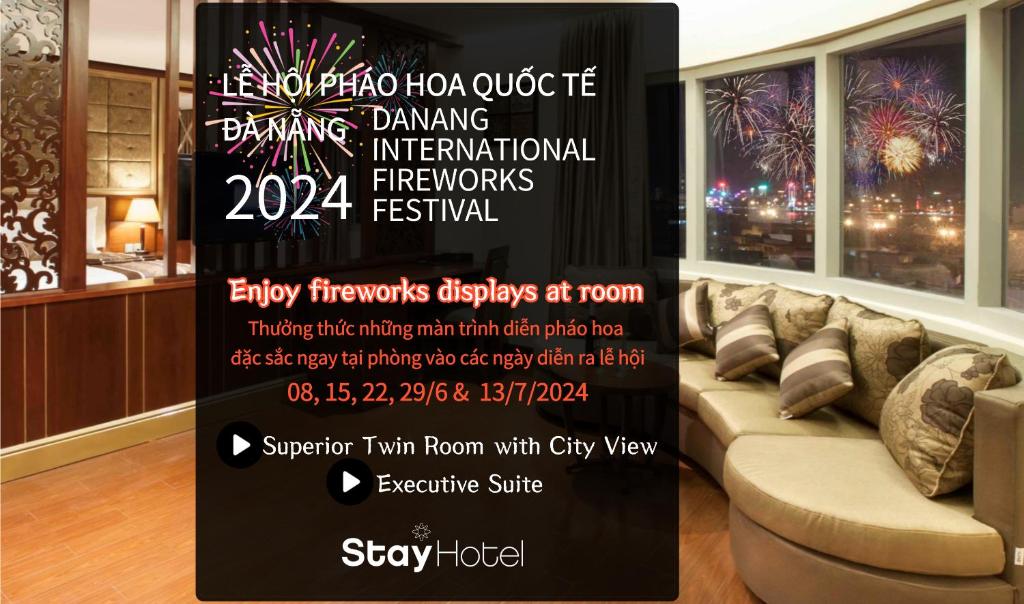 a sign in a living room with a couch and fireworks at Stay Hotel in Da Nang
