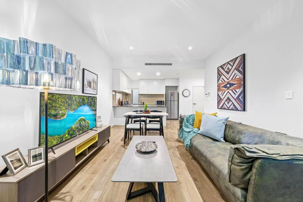 a living room with a couch and a table at Rooftop 2 Bed Apt With Terrace at Newtown in Sydney