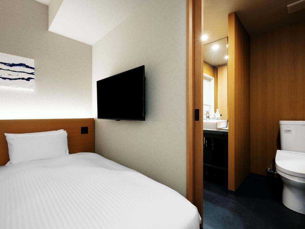 Postel nebo postele na pokoji v ubytování MIMARU Tokyo Station East